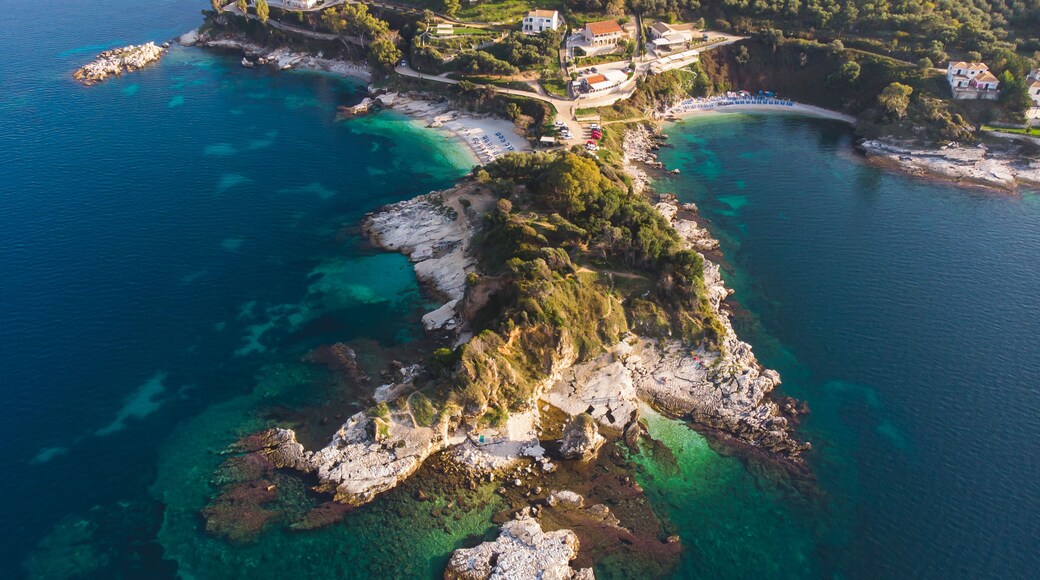 Aerial drone view of Kassiopi, village in northeast coast of Corfu island, Ionian Islands, Kerkyra, Greece in a summer sunny day, with marina, town, beach and castle