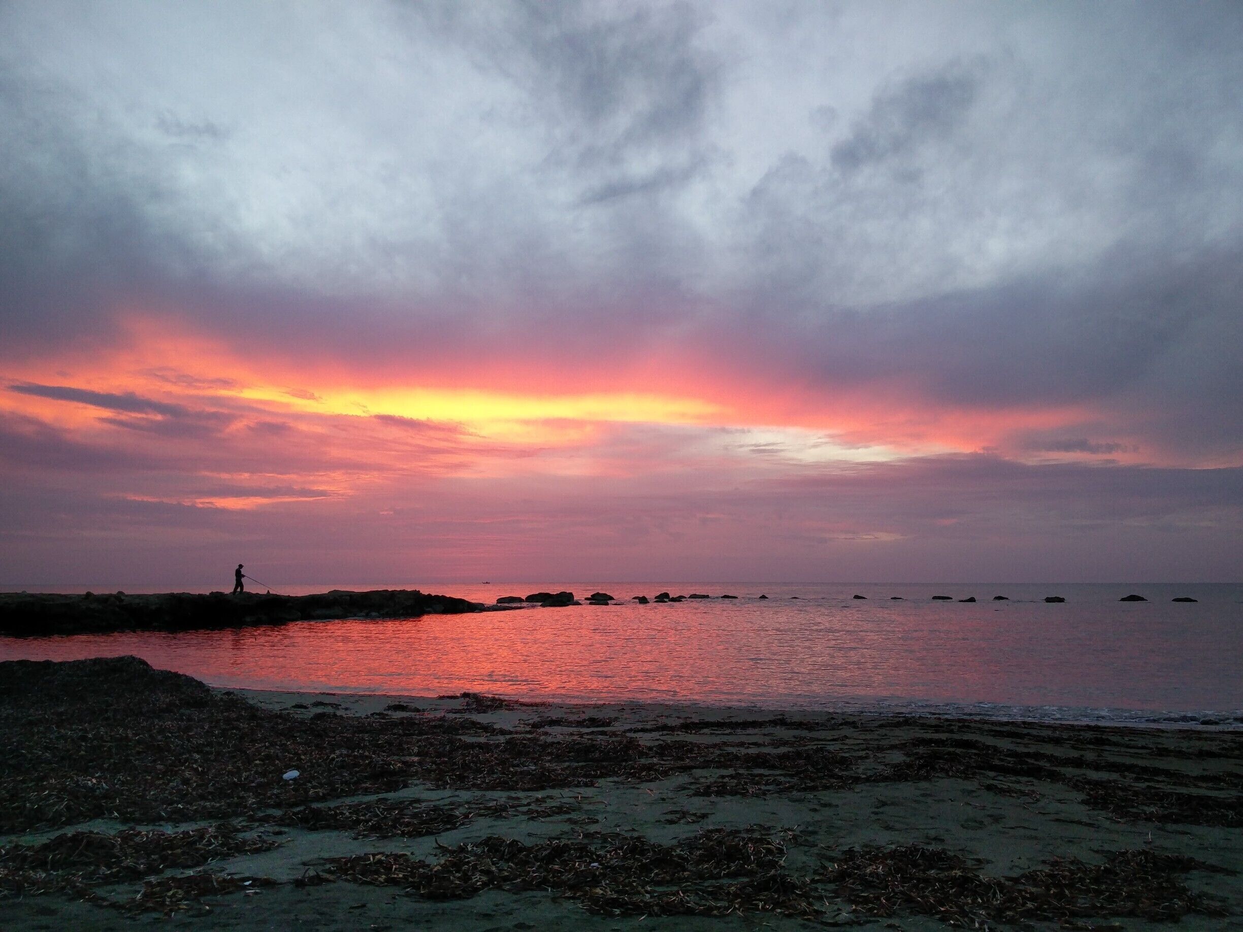 Lonely fisherman and sunset. If you are ever in Paphos take time to walk the coastline at sunset and you will find sights like this, and then head of to 7 St George's tavern, the most delicious meal in the Island! #lifeatexpedia #sunset #beach #getaway #Red #beachtips
