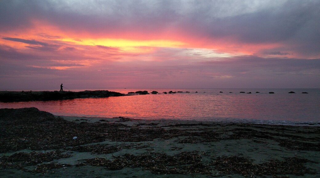 Lonely fisherman and sunset. If you are ever in Paphos take time to walk the coastline at sunset and you will find sights like this, and then head of to 7 St George's tavern, the most delicious meal in the Island! #lifeatexpedia #sunset #beach #getaway #Red #beachtips