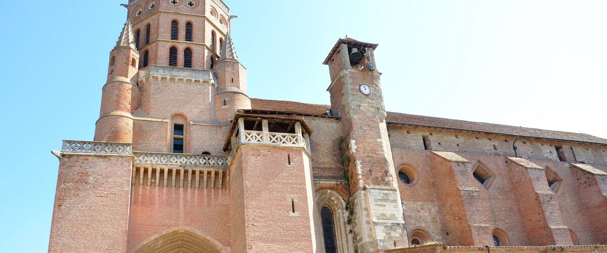 A large brick church with a bell tower and arched windows.