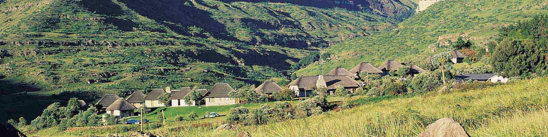 Drakensberg Mountains which includes tranquil scenes, a small town or village and mountains