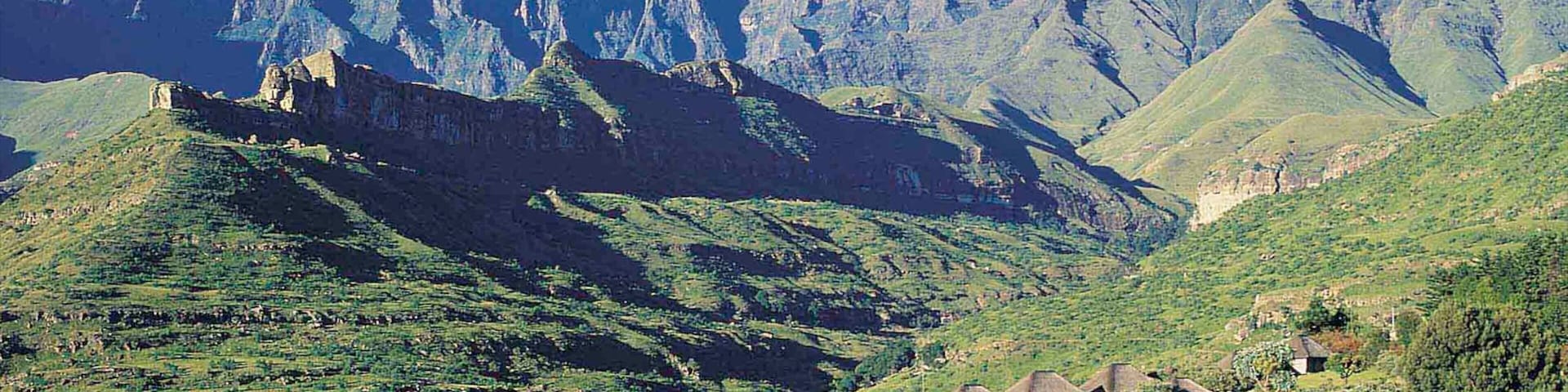 Drakensberg Mountains which includes tranquil scenes, a small town or village and mountains