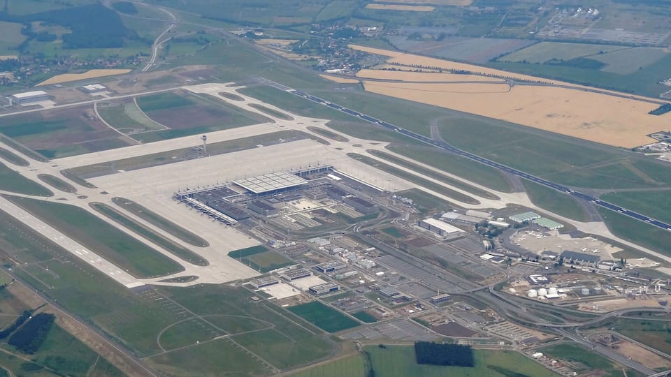 An airport with multiple runways, taxiways, and terminals.