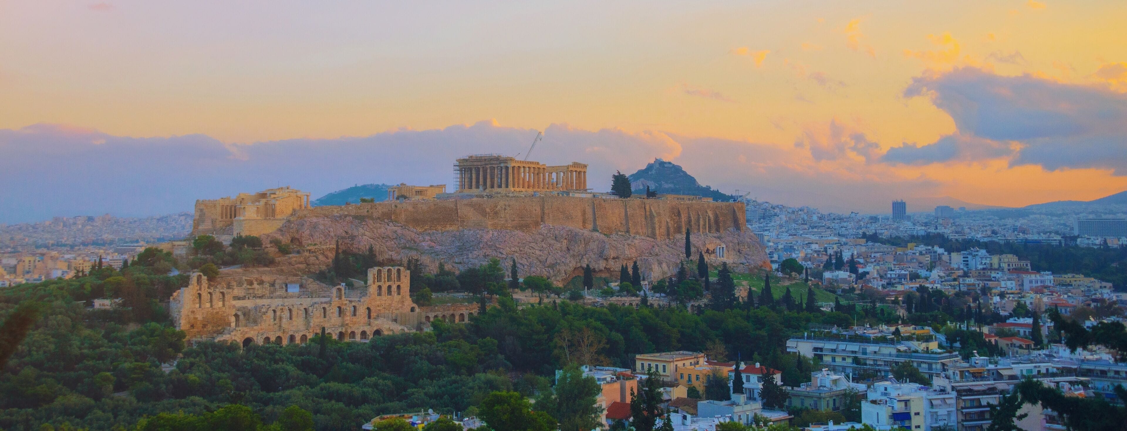 The Acropolis of Athens, ancient ruins, and the cityscape below.
