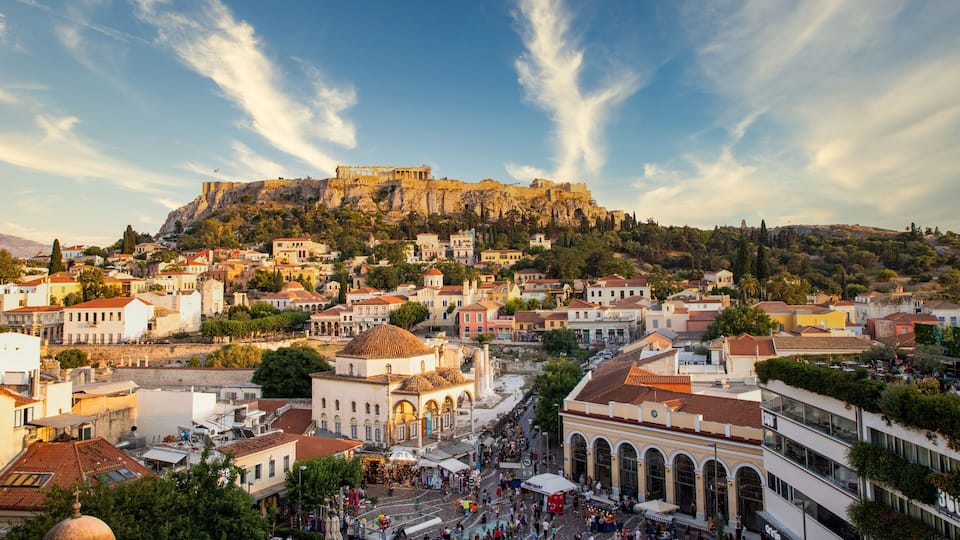 A historic town with a prominent castle on a hill, surrounded by residential buildings and a bustling market square.