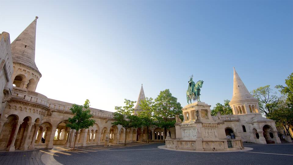 A historic building with multiple pointed towers and a central statue.