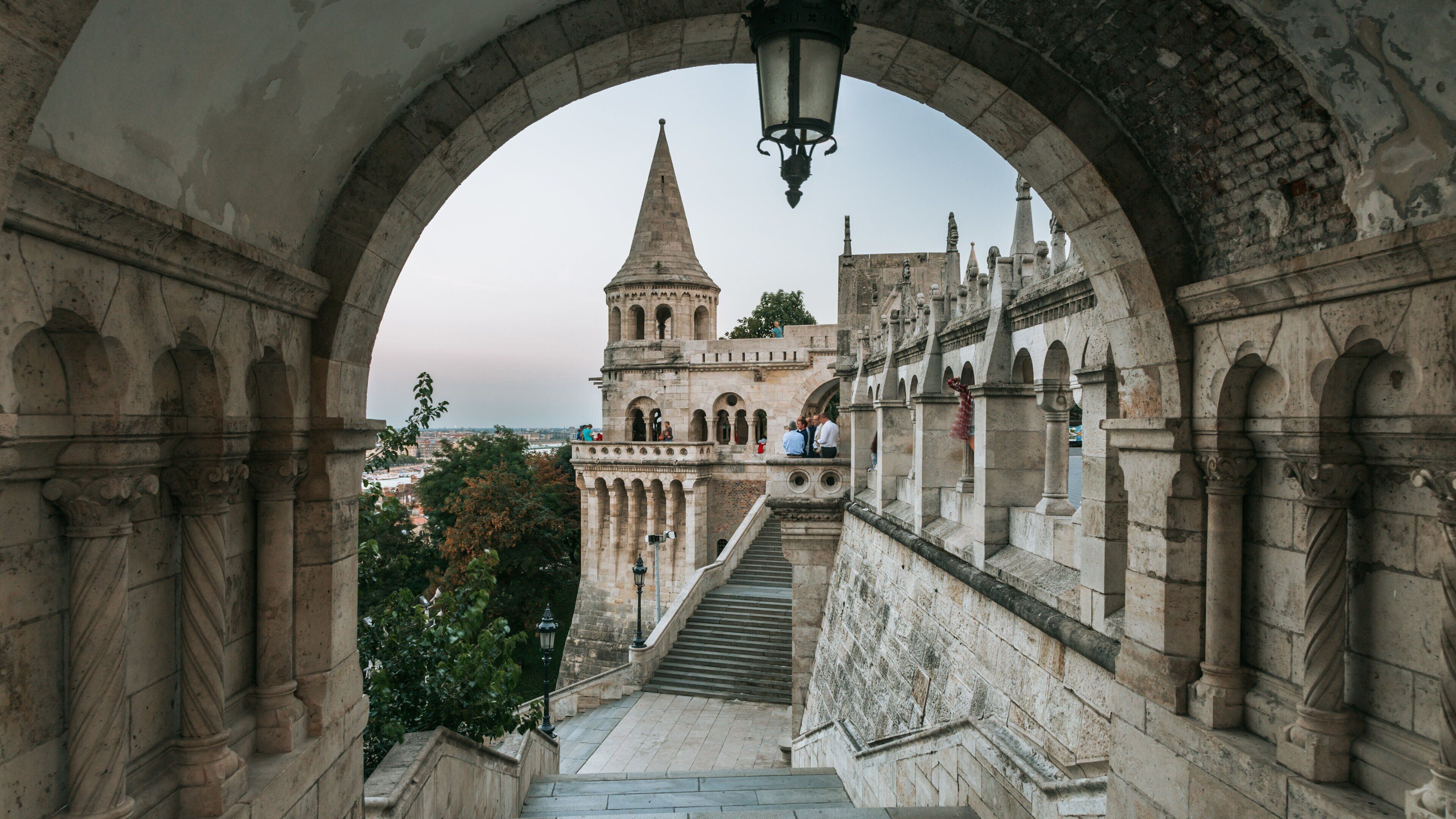 A stone staircase leading to a historic building with a tower.