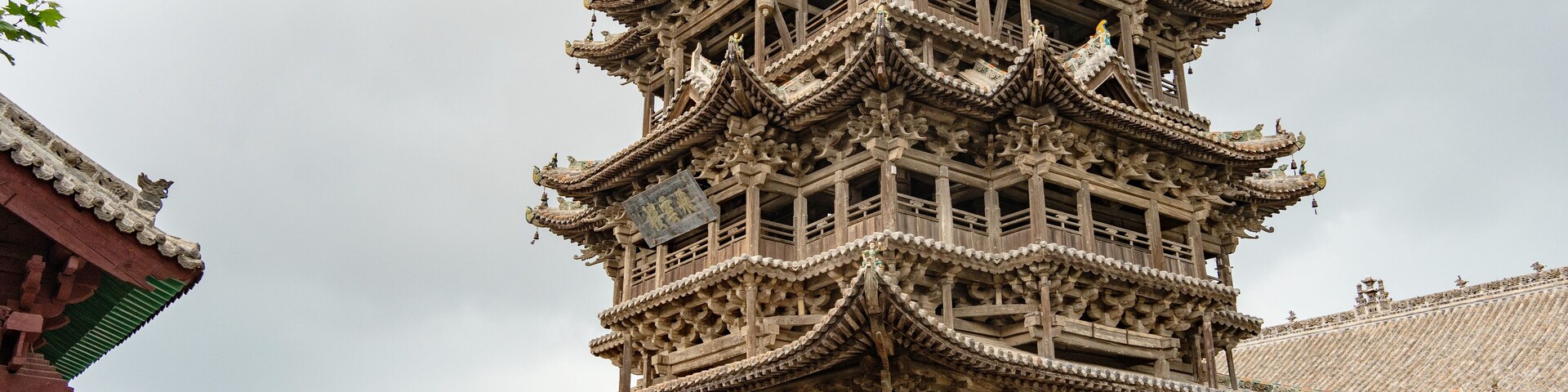 Una pagoda tradicional de varios niveles con detalles arquitectónicos intrincados y base de ladrillo.