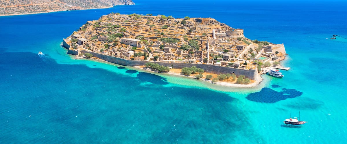 View of the island of Spinalonga with calm sea. Here were isolated lepers, humans with the Hansen's desease, gulf of Elounda, Crete, Greece.