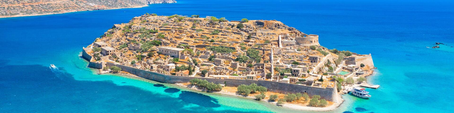 View of the island of Spinalonga with calm sea. Here were isolated lepers, humans with the Hansen's desease, gulf of Elounda, Crete, Greece.