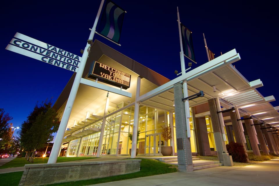 A modern building with a digital sign reading "Welcome to Yakima Convention Center."