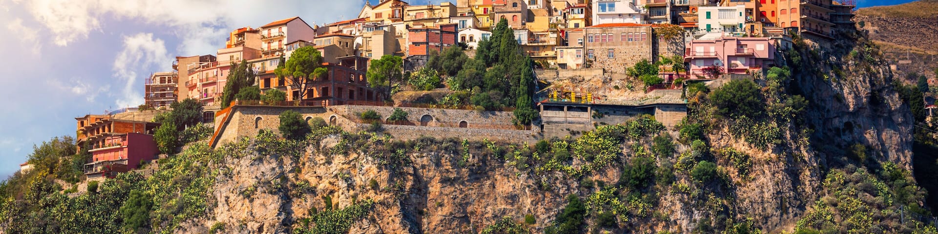 Castelmola: typical sicilian village perched on a mountain, close to Taormina. Messina province, Sicily, Italy. Castelmola town on rocky mountain top in Sicily, Italy.