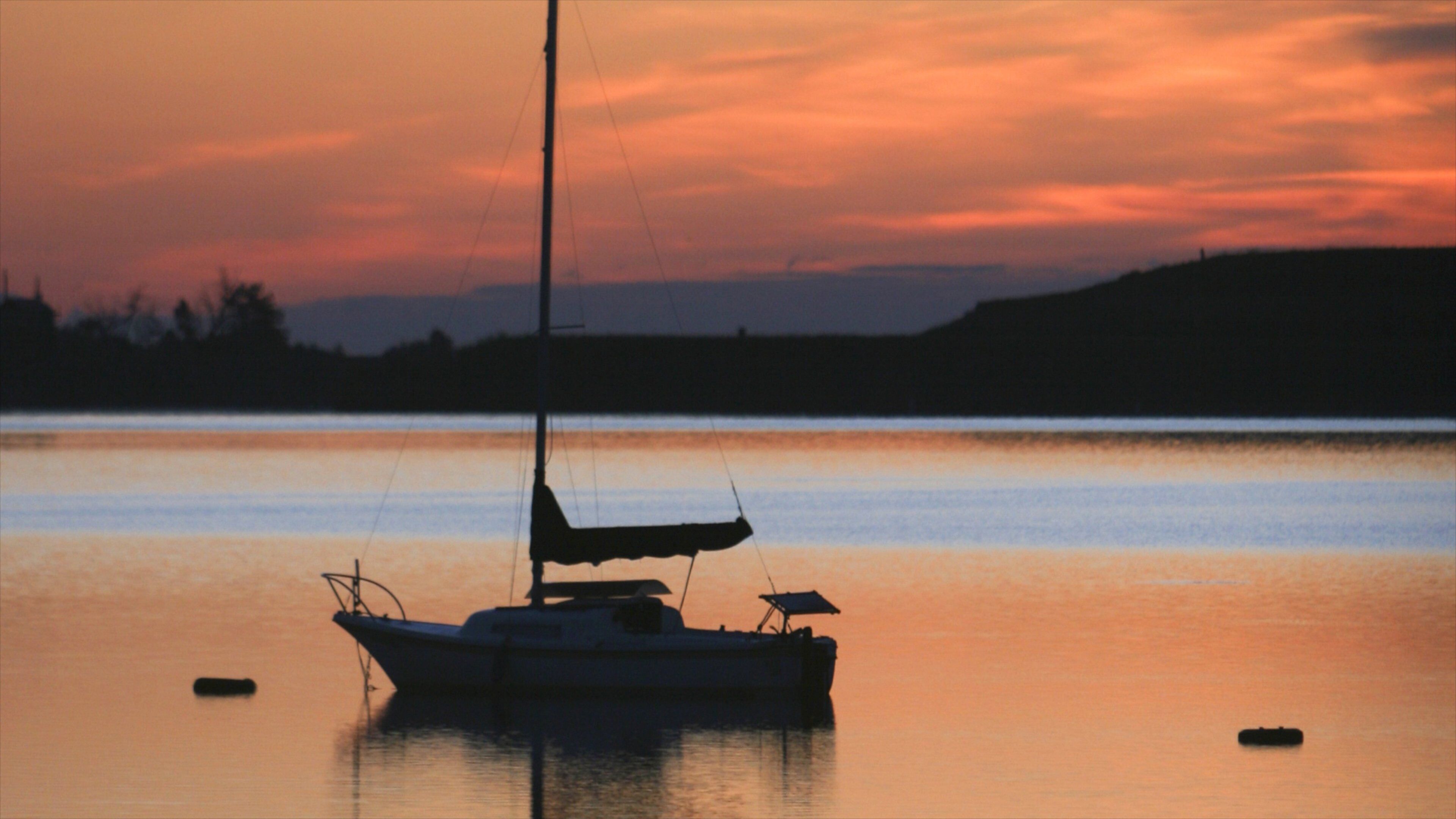 Boulder showing boating, a lake or waterhole and a sunset