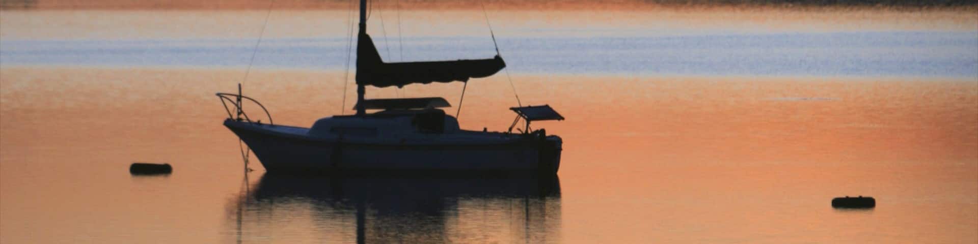 Boulder showing boating, a lake or waterhole and a sunset