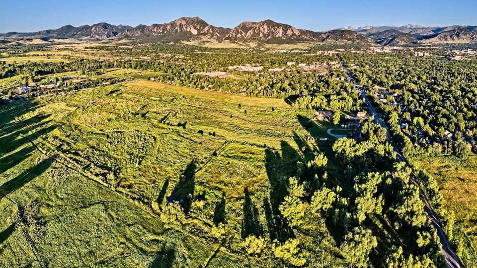 A mountainous landscape with terraced fields and scattered buildings.