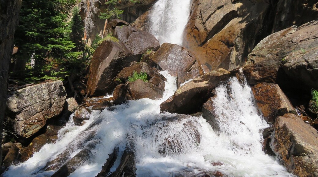 Ouzel Falls spills over a cliffside and enormous boulders, making it arguably one of the most beautiful waterfalls in Rocky Mountain National Park. Before reaching this 40-foot falls, the trail traces the course of several creeks and leads hikers past three other cascade waterfalls. A moderate 5.4 miles round trip hike