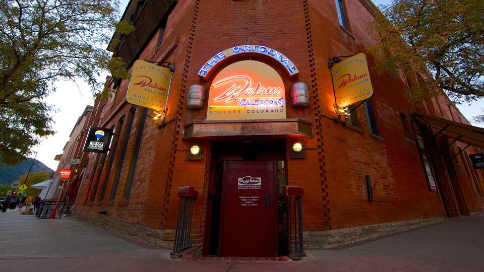 A brick building with neon signs for 'The Original Walrus Saloon' and 'The Original Boulder Colorado'.