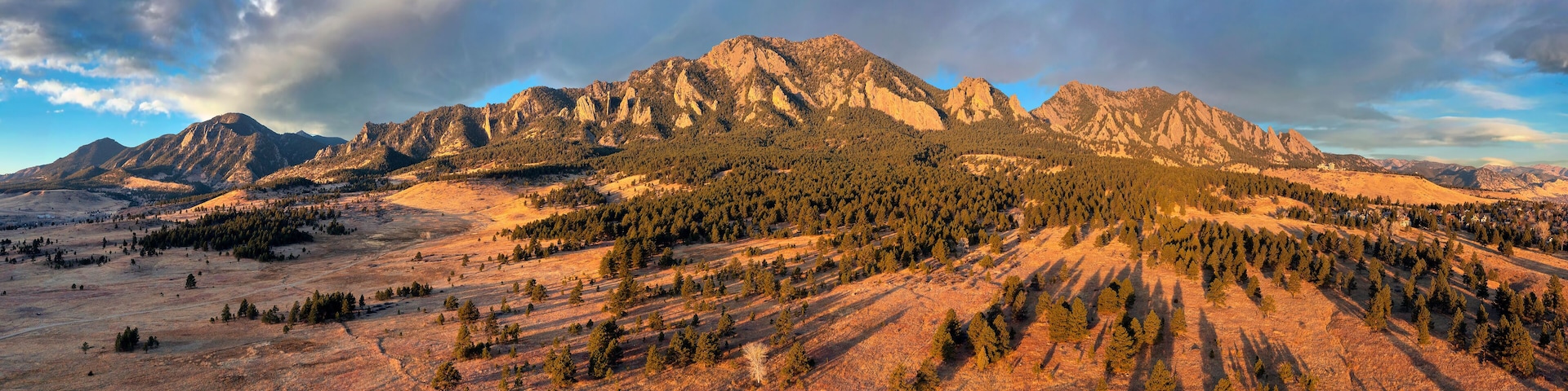 A mountainous landscape with dense forests and rocky peaks.