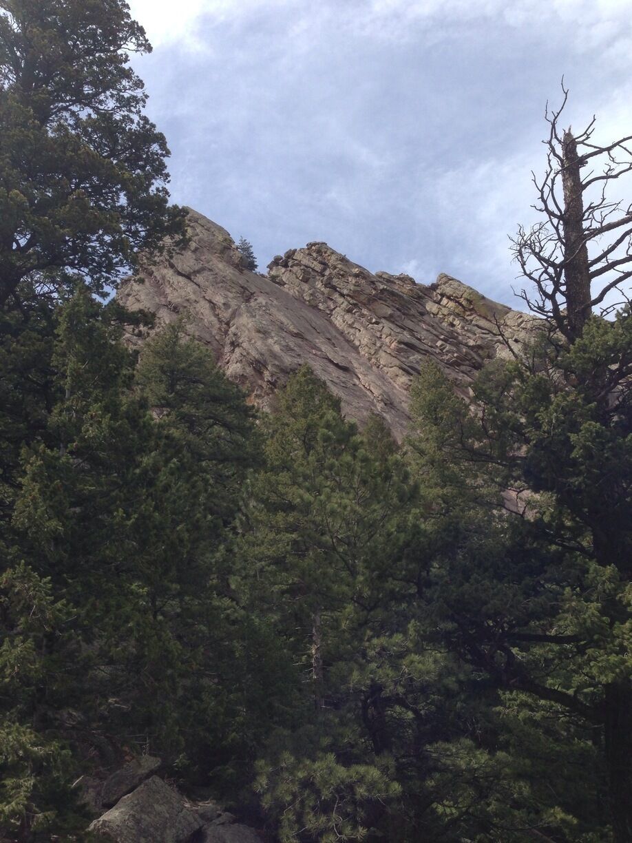 Three flatirons emerge from the trees at Chautauqua park