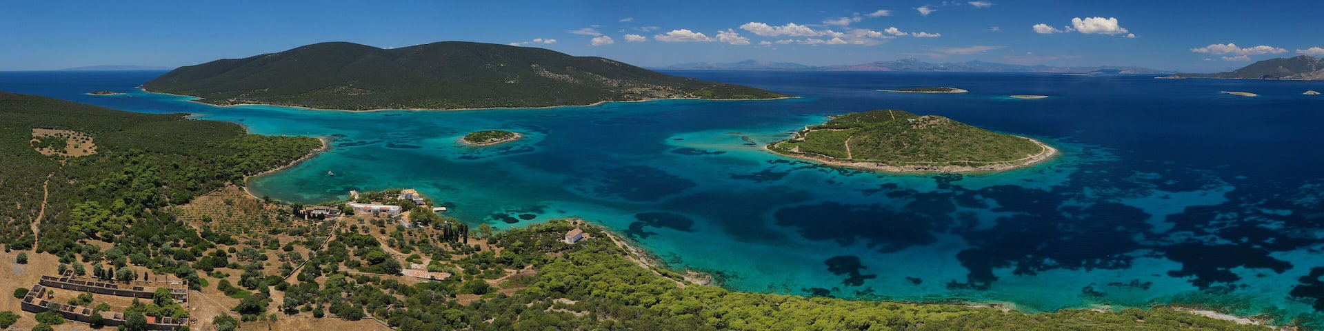 Aerial drone photo of beautiful paradise secluded island complex in gulf of of Petalioi or Petalion that form a blue lagoon with sandy turquoise beaches, South Evoia island near Marmari, Greece