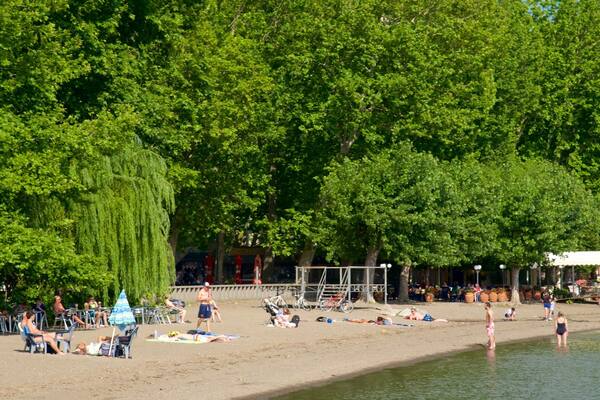 Lake Bolsena which includes general coastal views and a beach