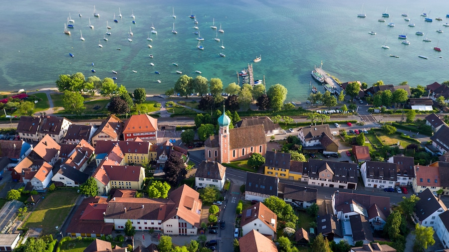A coastal town with a church, residential buildings, and a marina with boats.