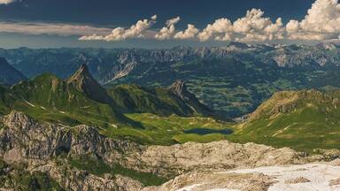 July 2016
Raetikon view from Wissplatte, Voralberg, Austria
Wissplatte with altitude 2.628 meters is an accessible summit in the Raetikon mountains just on the border of Austria and Switzerland. You can get there in ca. 1,5-2 hours from Tilisuna Huette or in ca. 6- 7 hours from Tschaggung in the Montafon valley.
In the view you can see the prominent spike-like peak of Schwarzhorn (2.460 m), Tilisuna Huette cabin (2.208 m altitude, just below the Schwarzhorn) and Tschaggungser Mittagspitze (2.160 m). Close to the hut you can see the Tilisuna see mountain lake (2.103 meters) under the Tilisuna Seehorn (2.342 m). The valley in the background is the Montafon valley (around 700 m alt.) with villages Vandans and Tschaggung. In the background you see the ranges of Lechquellengebirge (up to 2.700 m) and Verwallgruppe (up to 3.000 m).
On a sunny day it is just a rewarding view after the daily hike from the valley of Montafon.