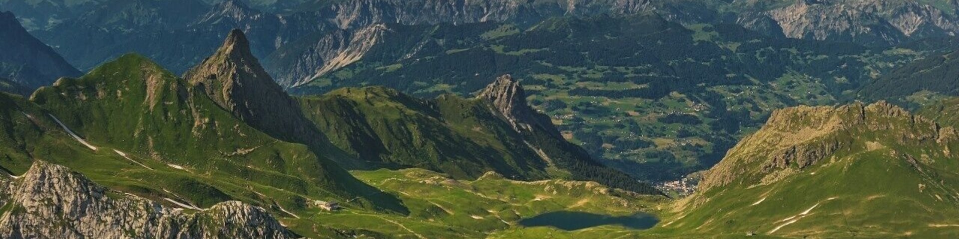 July 2016
Raetikon view from Wissplatte, Voralberg, Austria
Wissplatte with altitude 2.628 meters is an accessible summit in the Raetikon mountains just on the border of Austria and Switzerland. You can get there in ca. 1,5-2 hours from Tilisuna Huette or in ca. 6- 7 hours from Tschaggung in the Montafon valley.
In the view you can see the prominent spike-like peak of Schwarzhorn (2.460 m), Tilisuna Huette cabin (2.208 m altitude, just below the Schwarzhorn) and Tschaggungser Mittagspitze (2.160 m). Close to the hut you can see the Tilisuna see mountain lake (2.103 meters) under the Tilisuna Seehorn (2.342 m). The valley in the background is the Montafon valley (around 700 m alt.) with villages Vandans and Tschaggung. In the background you see the ranges of Lechquellengebirge (up to 2.700 m) and Verwallgruppe (up to 3.000 m).
On a sunny day it is just a rewarding view after the daily hike from the valley of Montafon.