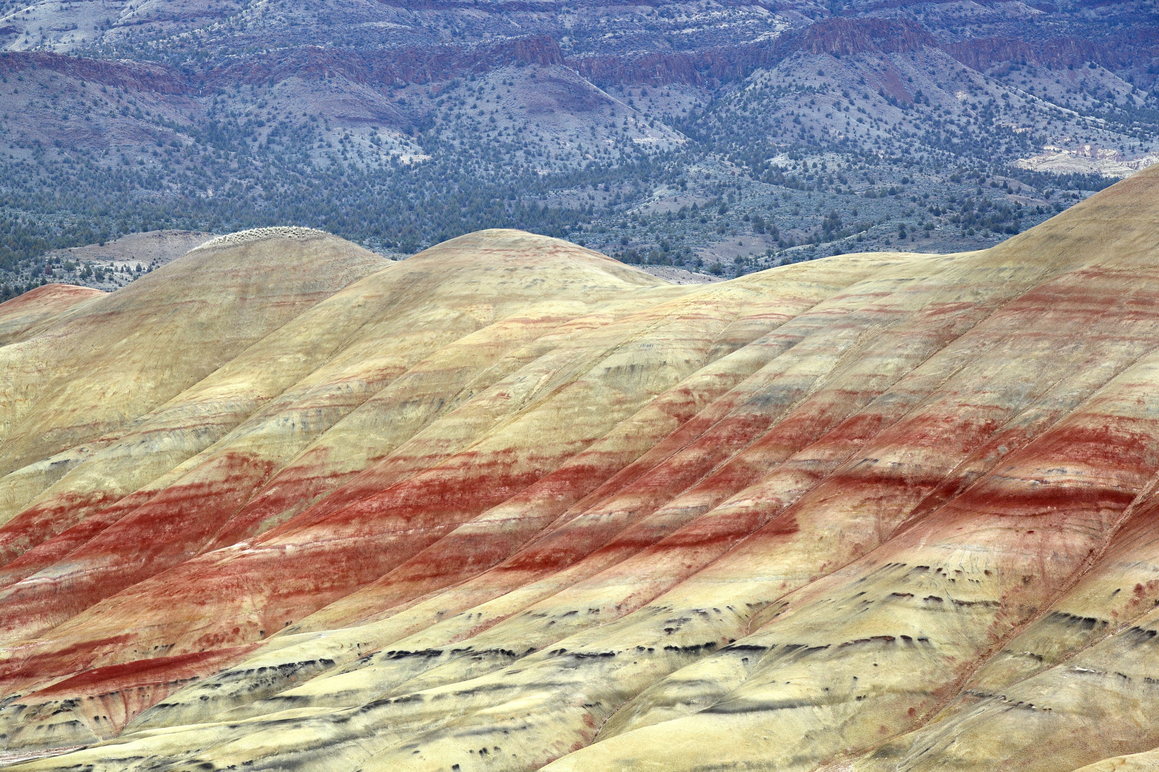 A mountain range with distinct red and yellow rock formations.