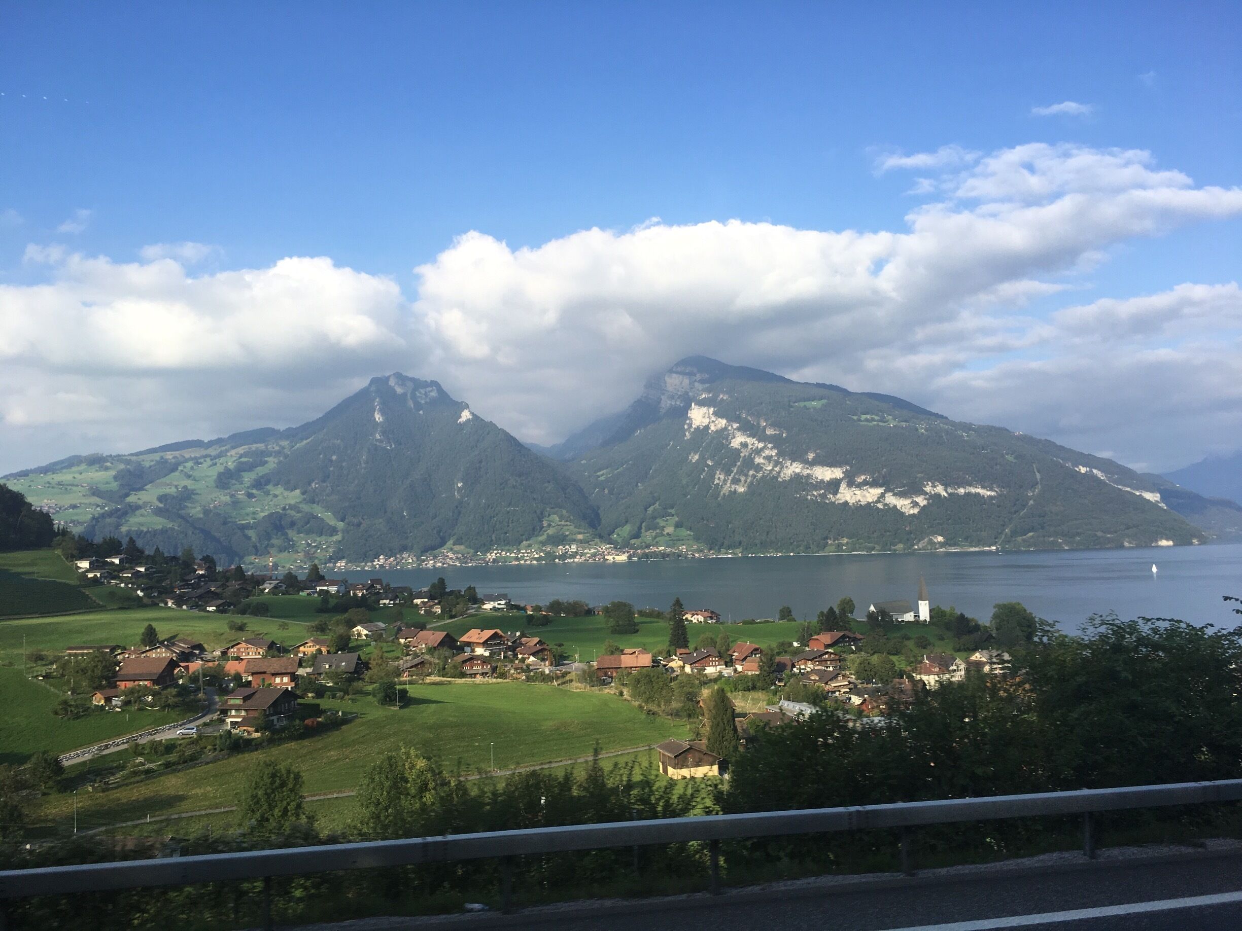 A mountainous landscape with a lake and a village.