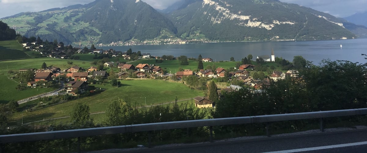 A mountainous landscape with a lake and a village.