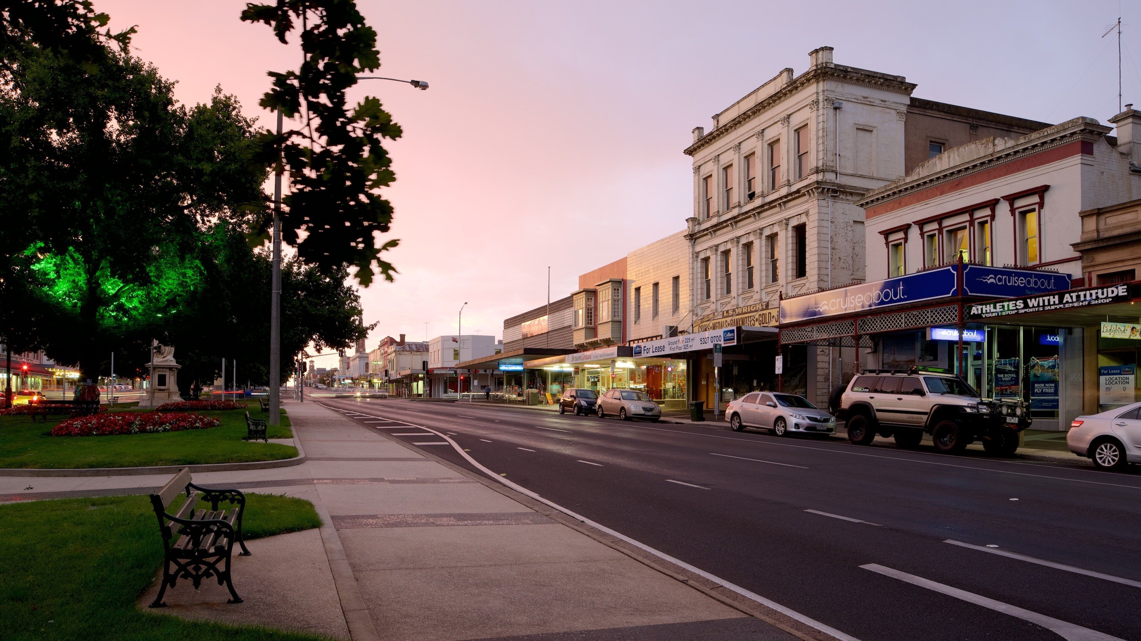 A street lined with shops and a building with a sign reading "Cruiseabout".