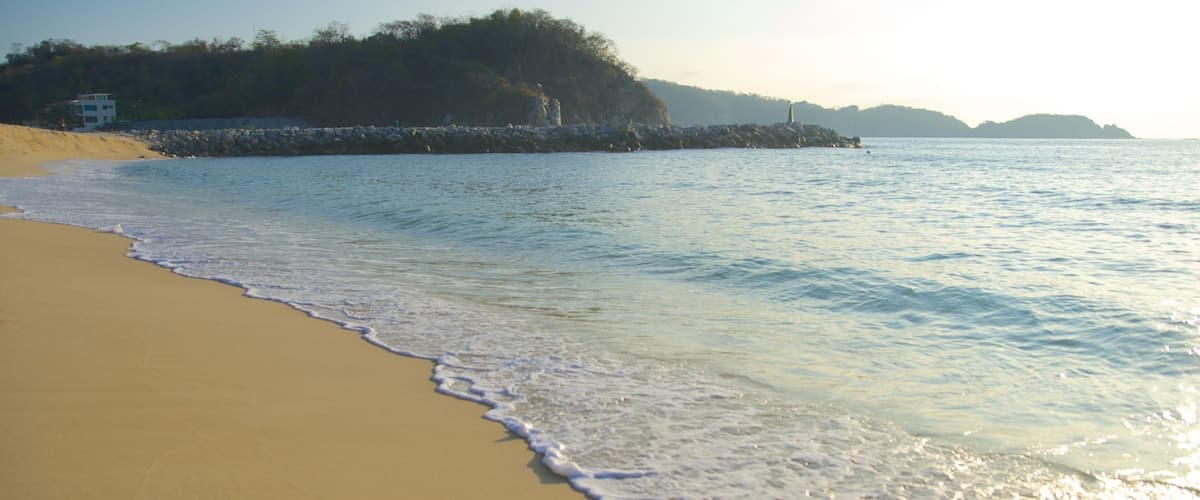 Bahia Chahue showing general coastal views, a sandy beach and a sunset