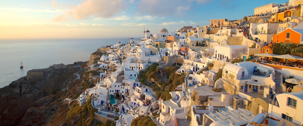 Oia featuring a sunset and a coastal town