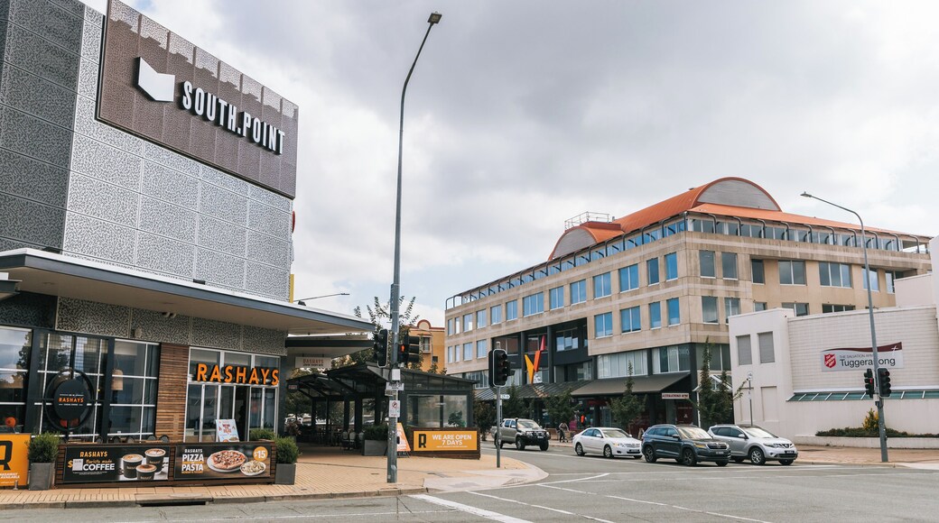 A street with a RASHAYS restaurant, a SOUTH.POINT sign, and a building with a red roof.