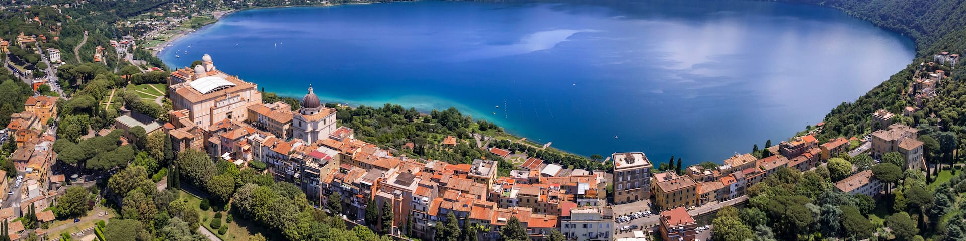Most scenic lakes of Italy - volcanic Albano lake , aerial drone panoramic view of Castel Gandolfo, village and crater of volcano. popular touristic site near Rome, famous as Pope residense