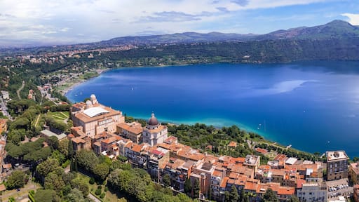Most scenic lakes of Italy - volcanic Albano lake , aerial drone panoramic view of Castel Gandolfo, village and crater of volcano. popular touristic site near Rome, famous as Pope residense