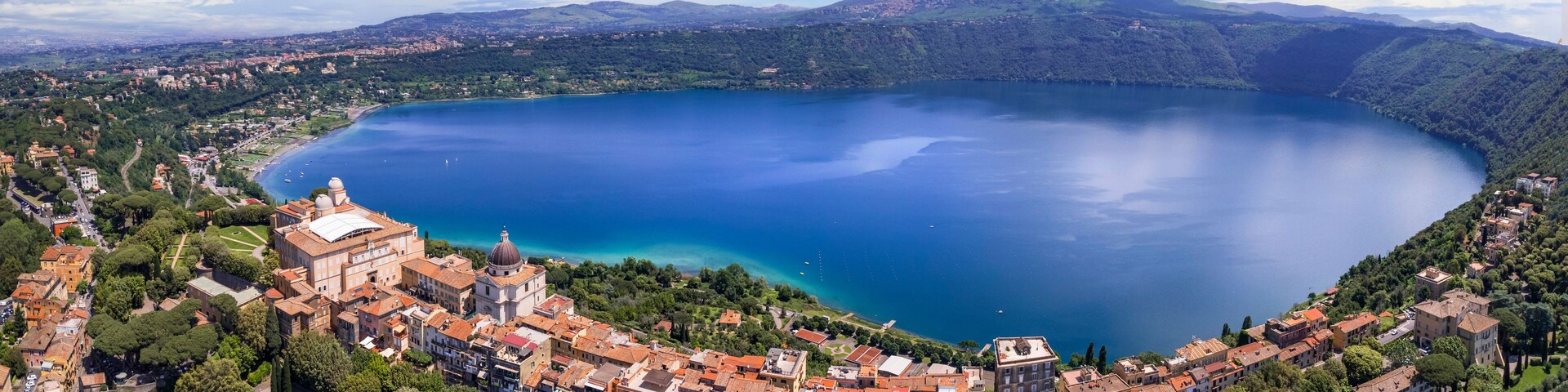 Most scenic lakes of Italy - volcanic Albano lake , aerial drone panoramic view of Castel Gandolfo, village and crater of volcano. popular touristic site near Rome, famous as Pope residense