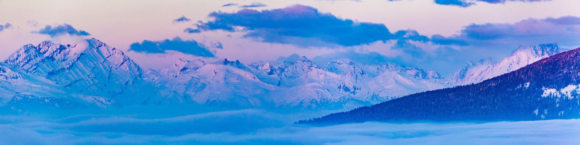 Scenic panorama sunset landscape of Crans-Montana range in Swiss Alps mountains with peak in background, Crans Montana, Switzerland.