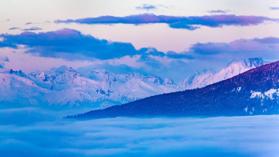 Scenic panorama sunset landscape of Crans-Montana range in Swiss Alps mountains with peak in background, Crans Montana, Switzerland.