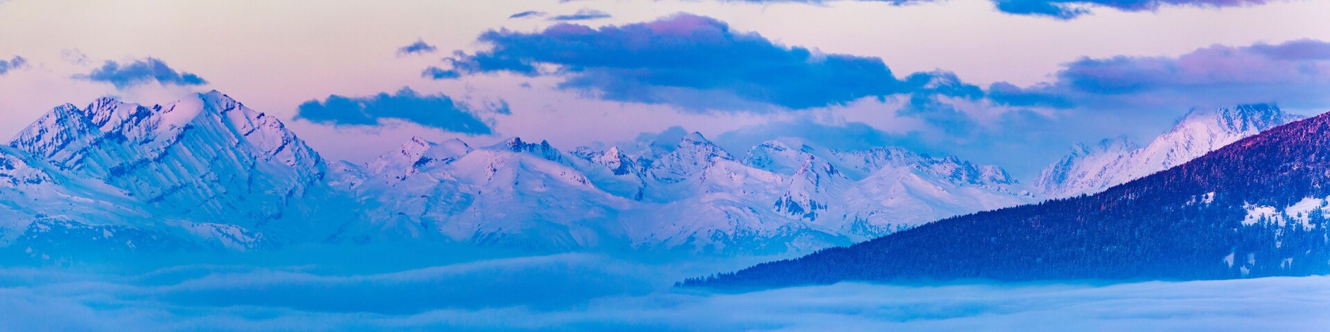 Scenic panorama sunset landscape of Crans-Montana range in Swiss Alps mountains with peak in background, Crans Montana, Switzerland.