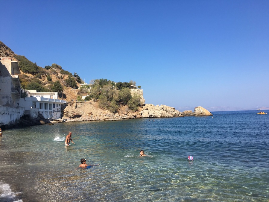 Therma ! 2 kms away from the port with a very clear sea. Its not very modern but good to go. You can take a boat 200 meters from the port to come to Therma for 1 euro