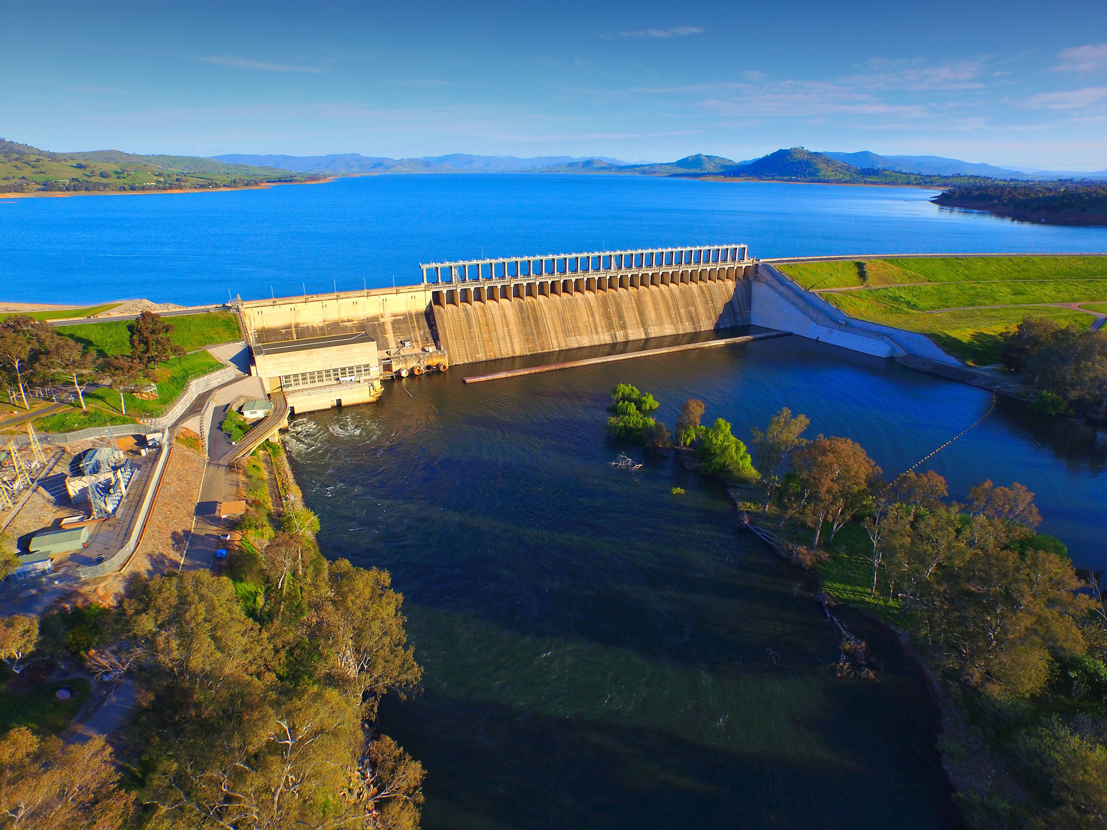 A dam with a lock system, surrounded by water and greenery.