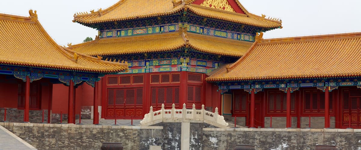 A traditional Chinese building with ornate golden roofs and red walls.