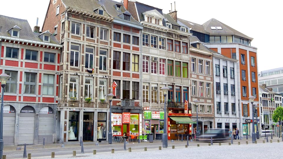 A street with historic European architecture, including a variety of shops and a café.