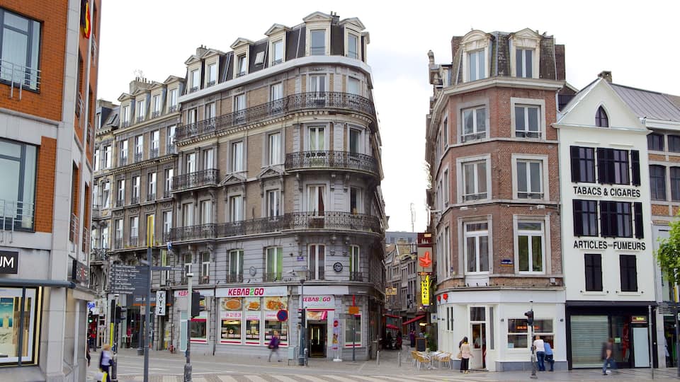 A European street with historic buildings, a kebab shop, and a tobacque shop.