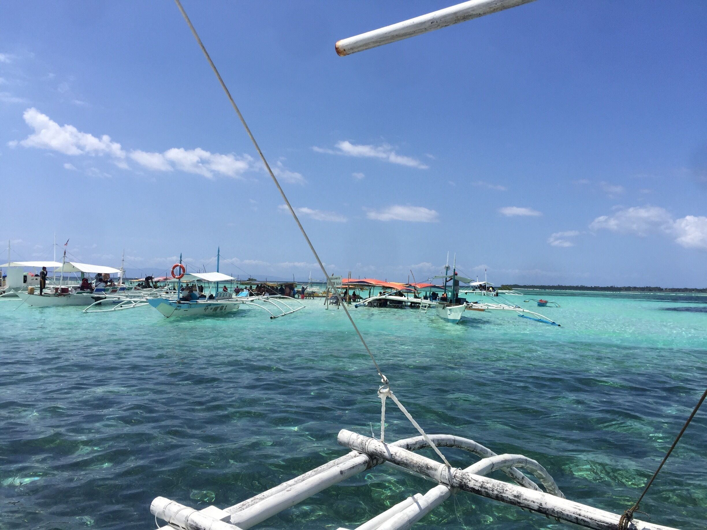 Clear blue green waters for a pit stop with food stalls selling fried banana plantains, fresh pineapples and squid.
