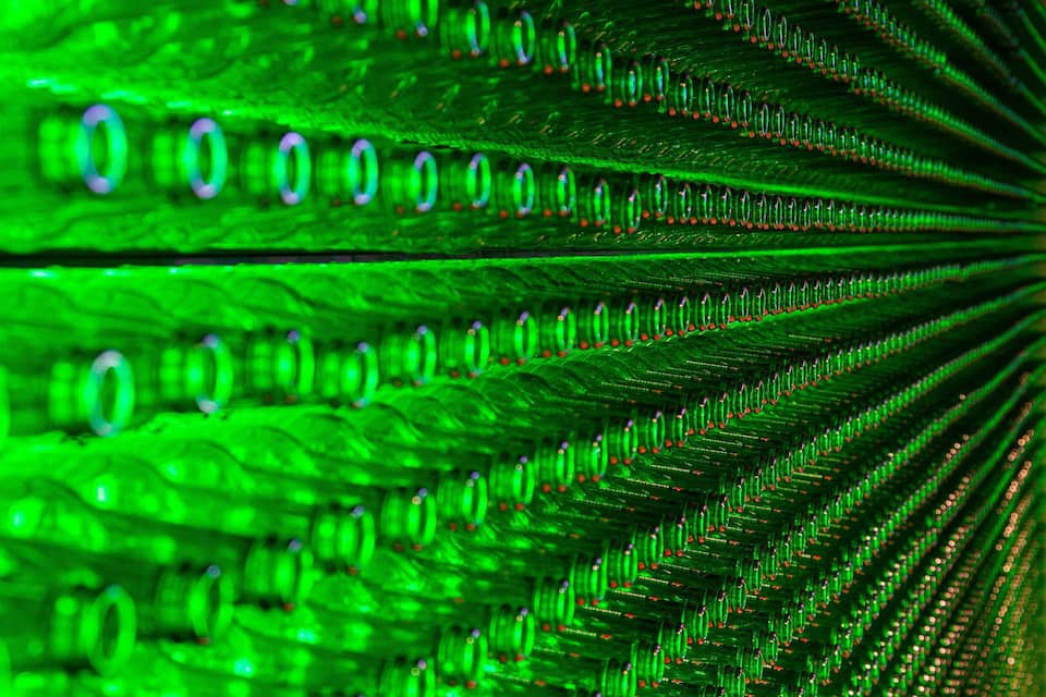 A close-up of a green, reflective surface with a pattern of circular shapes and lines.