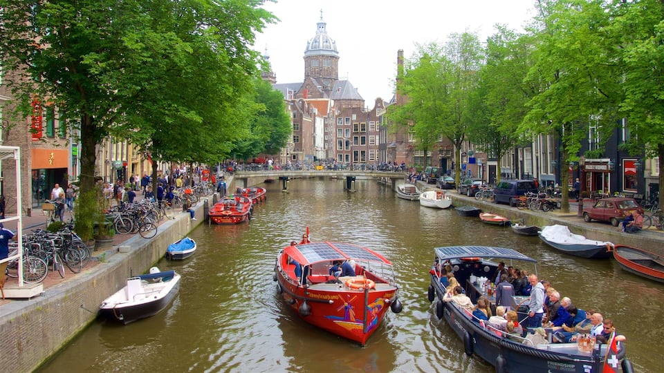 A canal with boats, a bridge, and historic buildings.