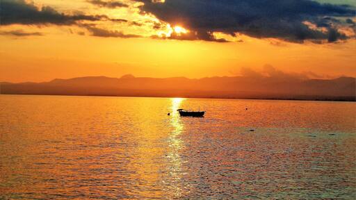 I took this photo from the seaside village of Paralia Vergas, near Kalamata, Greece. Beautiful golden memories of last Summer! Paralia Vergas is just a few KM from Kalamata and is one of the best spots in the area to relax and gaze at the sea and mountains. Especially at sunset! And here in this scene I love how peaceful and calm it is. And the boat makes it idyllic!